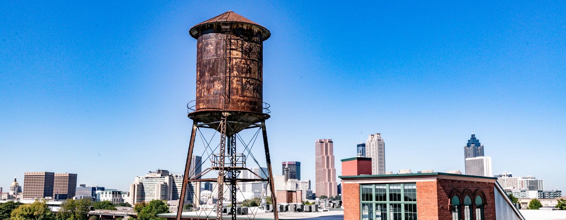a water tower in front of a city